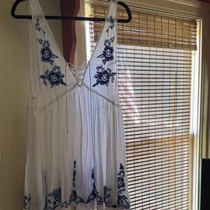 Free People. Size medium. No staining. White Dress with Blue Floral Embroidery.